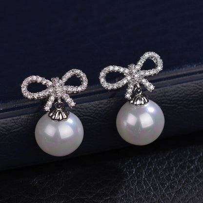 1 Pair Elegant Bow Knot Inlay Copper Alloy Artificial Pearls Zircon White Gold Plated Drop Earrings