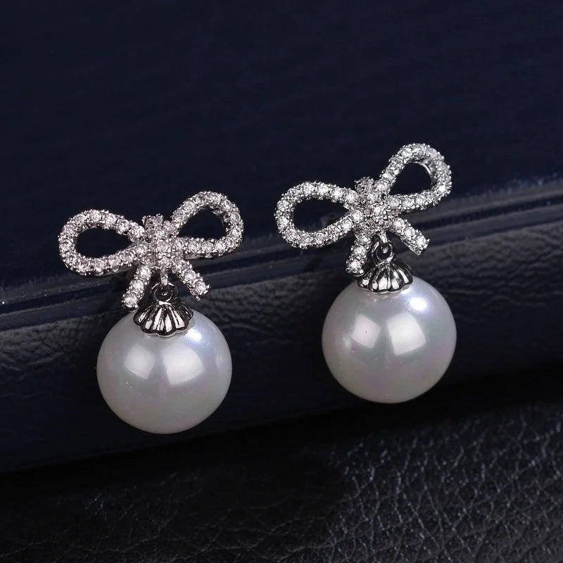 1 Pair Elegant Bow Knot Inlay Copper Alloy Artificial Pearls Zircon White Gold Plated Drop Earrings